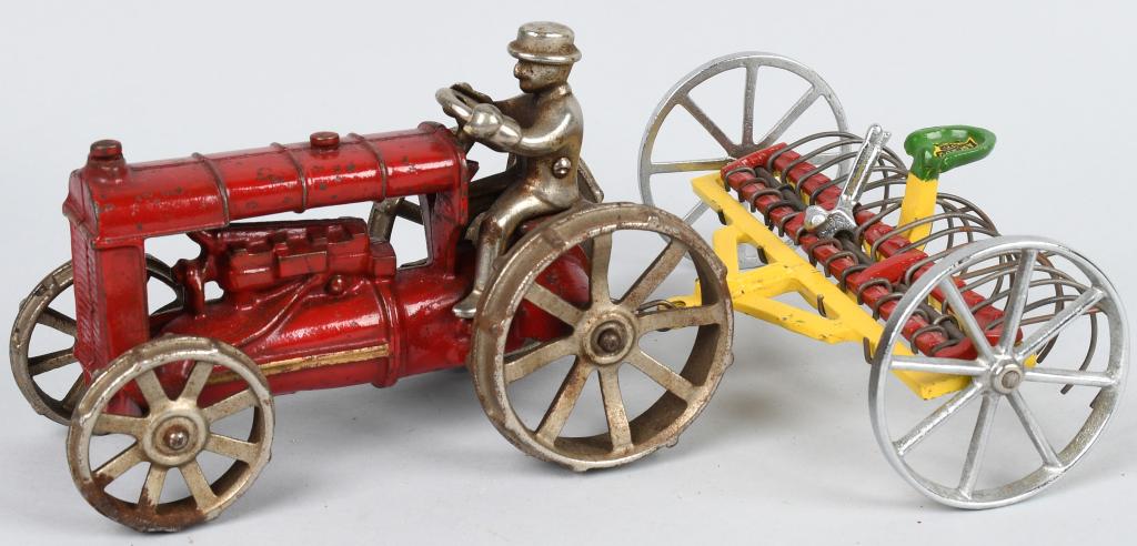 ARCADE CAST IRON FORDSON TRACTOR & HAY RAKE: Original cast iron Fordson Tractor and Hay Rake. Both all original with very nice paint. Tractor is red with nickel wheels. Hay Rake is very nice with Arcade sticker. No breaks or issues. A very nice