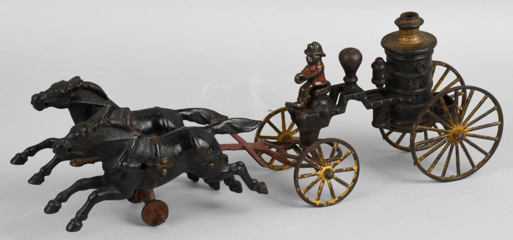 WILKINS cast iron HORSE DRAWN FIRE PUMPER: Wilkins small size cast iron fire pumper circa 1895. The toy is pulled by two classic 7" Wilkins horses. The tongue of the front end has been over painted. The pumper has paint wear but includes the o