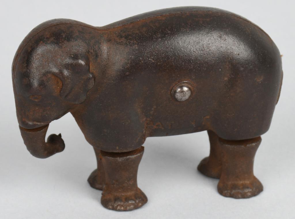 IVES cast iron WALKING ELEPHANT PAT. 1873: Original IVE's ramp walking cast iron elephant. Legs move and trunk swivels. Patent dated 1873. Complete except for string tail. Has a hair line crack on left side. 3 1/2" by 2 1/2". Very Good