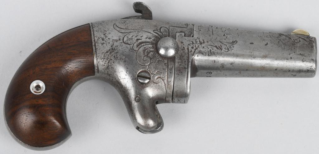 NATIONAL ARMS COMPANY SINGLE SHOT .41 DERRINGER: Serial #8260. Made in Brooklyn from 1865-1870 before design and production was sold to Colt in 1870. It features an engraved iron frame with a 2" barrel and chambered for the .41 rim fire cartridge. I