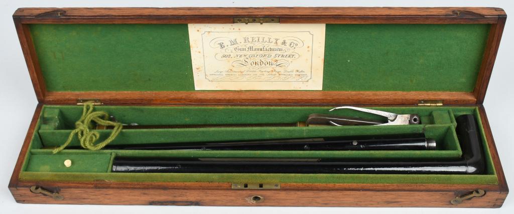 Ca. 1850'S OAK CASED LONDON AIR POWER CANE GUN: This is the most elaborate cane gun we have encounterd. First off, it comes in its original oak case with the London dealer trade label inside lid and the dividers are covered in green felt. The main
