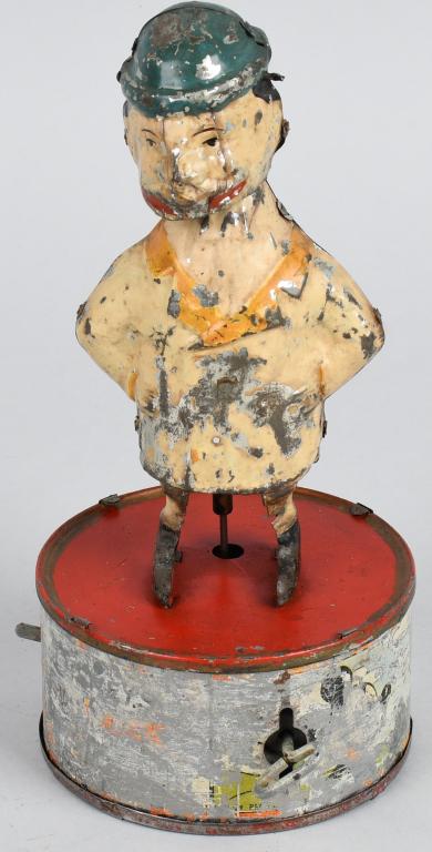 GERMAN WINDUP HAND PAINTED MAN ON BASE: German hand painted man thats mounted on what looks to be a Marx base. Wind the toy up and the man has mulitple actions. Windup works. 9" Very Good