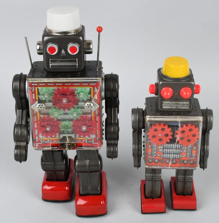 2- GEAR ROBOTS: Both all original. Includes windup Gear Robot. Working with crack in chest plate. Plus battery operated Gear Robot not working with some corrosion in battery box. Largest 11 1/2" Very Good