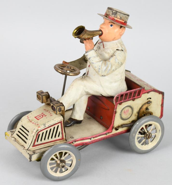 GERMAN LEHMANN tin windup TUT TUT AUTO: The toy is all original except for replaced front wheels. The rear wheels have been painted to match. The toy has a working horn bellows. 7" Very Good