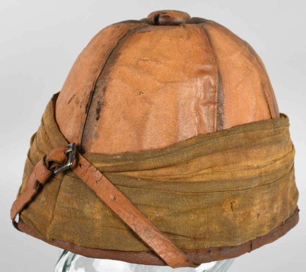 BOER WAR LANCASHIRE HUSSARS PITH HELMET: Late 19th Century British pith helmet with khaki sweatband and battle flash on the left side, as well as copper-toned cap badge for the Lancashire Hussars, a regiment activated for service in the Seco