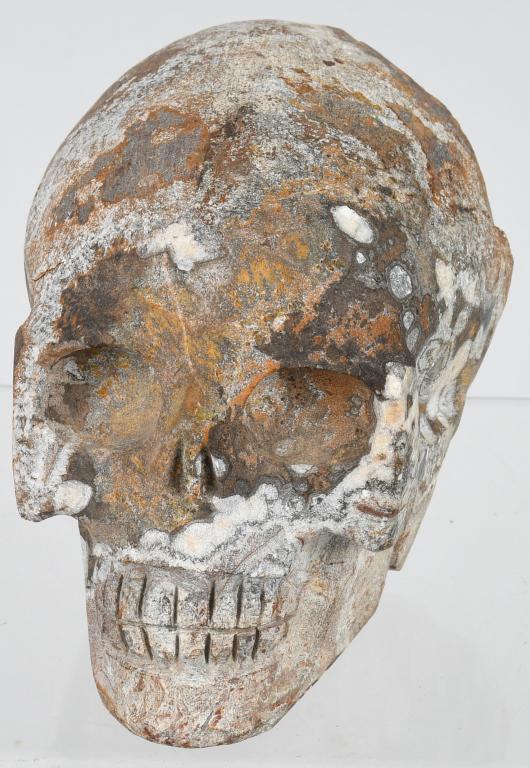 GEODE SKULL CARVING: Approximately 5.5" x 3.5" x 2" stone geode with the face and crown of a skull with exposed geode in the back and underside. Very Good