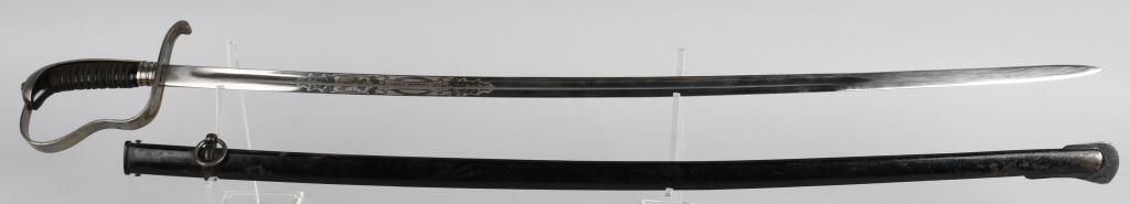 WWI BAVARIAN SWORD WITH SCABBARD: WWI Bavarian Sword with Original Scabbard. Blade has double etched panels with the saying "In Treue Fest!". One side of the blade etching features a Coat of Arms. Handle is wood covered by a thin blac