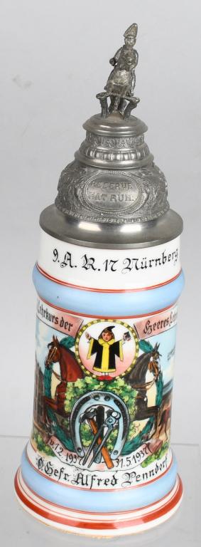 WWII NAZI GERMAN NAMED ARTILLERY STEIN NUREMBURG: Half-liter full-color painted beer stein with decorative metal top featuring a sculpted cavalry soldier on horseback and a Prussian lion on the thumb tab. Approximately 12.8" tall featuring personaliz