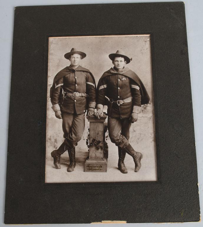 1889 US CAVALRY SOLDIER PHOTO LEADVILLE CO: Taken at Leadville Colorado, full-body photo of two US Army Cavalry soldiers with capes and model 1881 cavalry trooper uniforms standing beside a wooden podium. 4" x 6.5" and matted. Excellent