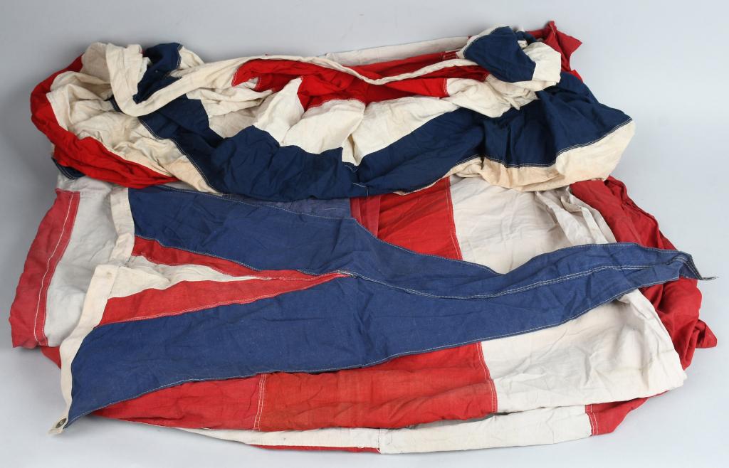 5 PIECE LOT EARLY PATRIOTIC & NAUTICAL FLAGS: Lot of early 20th Century cloth buntings and nautical flags. Includes a pair of white cross patterned nautical / naval flags which measure approximately 56" x 80", a triangular flag which measures 24"