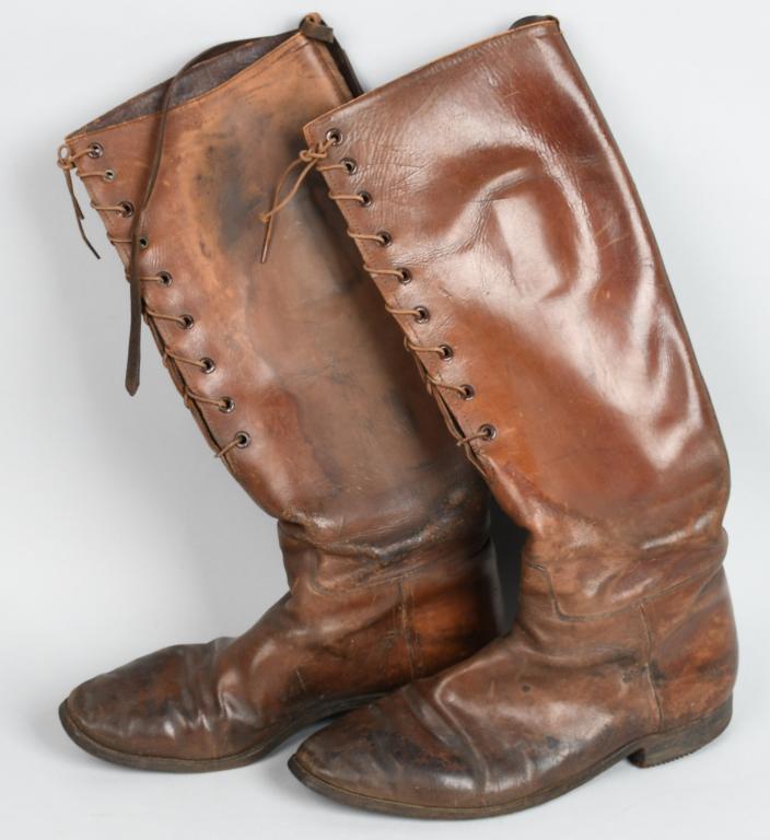 WWI US ARMY OFFICERS LACE-UP BOOTS: Brown leather boots, approximately 17.5" tall, measuring approximately 10.5" from heel to toe on the outside of the sole. 9 eyelets, original cord laces intact, with nailed heels and leather straps at