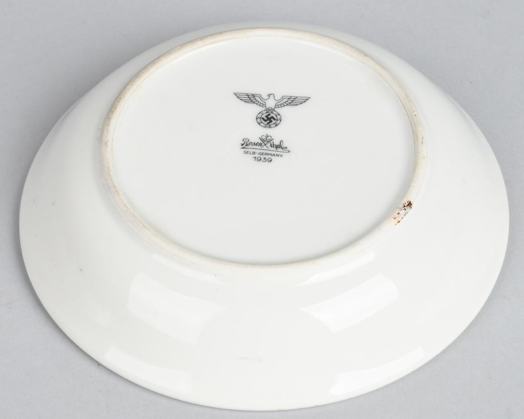 WWII NAZI GERMAN MARKED SAUCER DATED 1939: Small glazed white porcelain saucer or bowl, measuring approximately 6.5" across. Marked on the bottom Rosenthal Selb-Germany, dated 1939, featuring a right-facing Nazi eagle over a mobile swastika. E