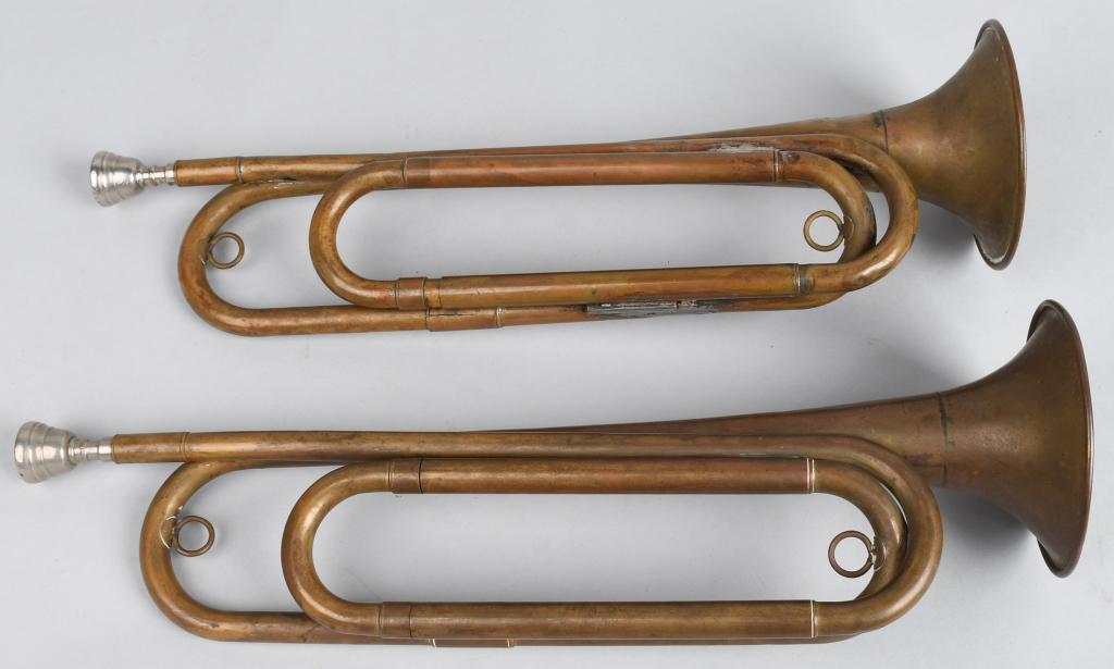 WWI US 2 US REGULATION ARMY BUGLES: WWI era brass bugles both marked "US REGULATION" and "MADE IN THE USA" near the bell. Both have detachable mouthpieces, and both are functional. Light service and handling wear, both exhibit age. Very