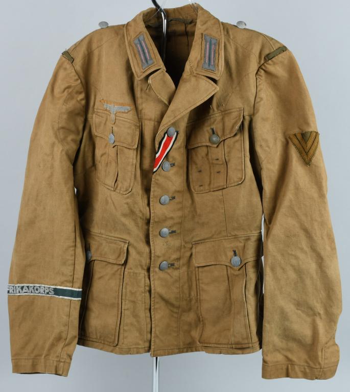 WWII NAZI GERMAN PANZER TROPICAL FIELD BLOUSE: Light weight ribbed khaki/olive cotton twill construction field blouse features a vertical six button front closure with small opened fold back peak lapels and a lay down collar. The field blouse has 