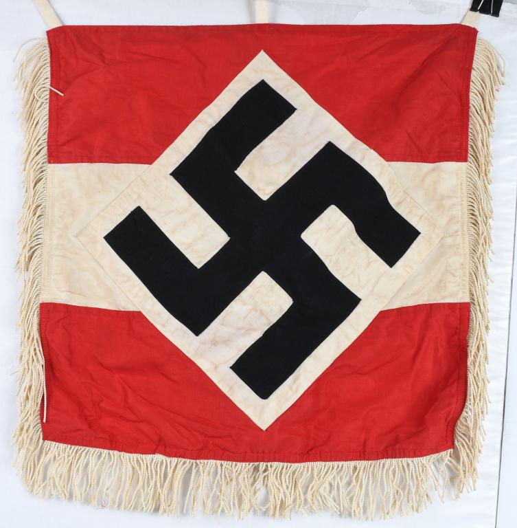 WWII NAZI GERMAN HJ FANFARE TRUMPET BANNER: An approximately 46cm square double sided multi-piece cotton construction banner with four doubled tie strings along its upper edge for affixing it to a trumpet. To both sides is the typical HJ patter