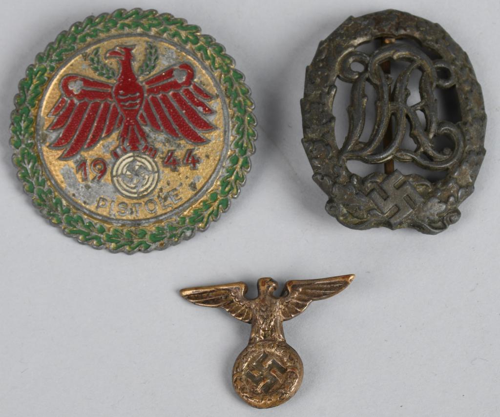 WWII NAZI GERMAN SPORTS AND SHOOTING BADGE LOT: Lot of three Nazi German medal lot consisting of a 1937 pattern die struck bronze award. The badge is in the form of a vertical oval oak leaf wreath with a mobile swastika and bow to its base encompas