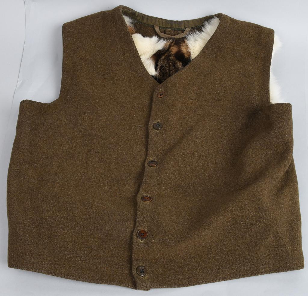 WWII NAZI GERMAN FUR LINED WOOL VEST: Apparently home-made for a gift for a German soldier on perhaps the Russian front, this wool, button-down, sleeveless, cotton-backed vest has a hand-sewn pelt of wildcat fur in the back, an cotton col