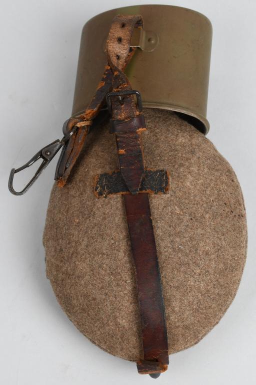 WWII NAZI GERMAN M42 PAINTED CANTEEN AND CUP: Aluminum flask style WWII German canteen, unmarked on the bottle - bottle is painted red. Comes in feldgrau / gray wool carrying case with for flat brown snaps on the side, leather hanger, and OD gree