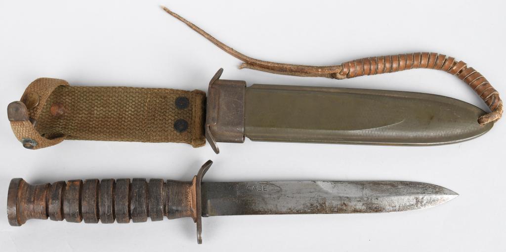WWII US CASE M3 FIGHTING KNIFE in M8 SCABBARD: Blade-marked Case M3 Fighting knife with stacked leather washer handle, in original BM Co. M8 Scabbard. Has leather thong attached to tip of scabbard. Blade measures approximately 6.7" and 12.75" over