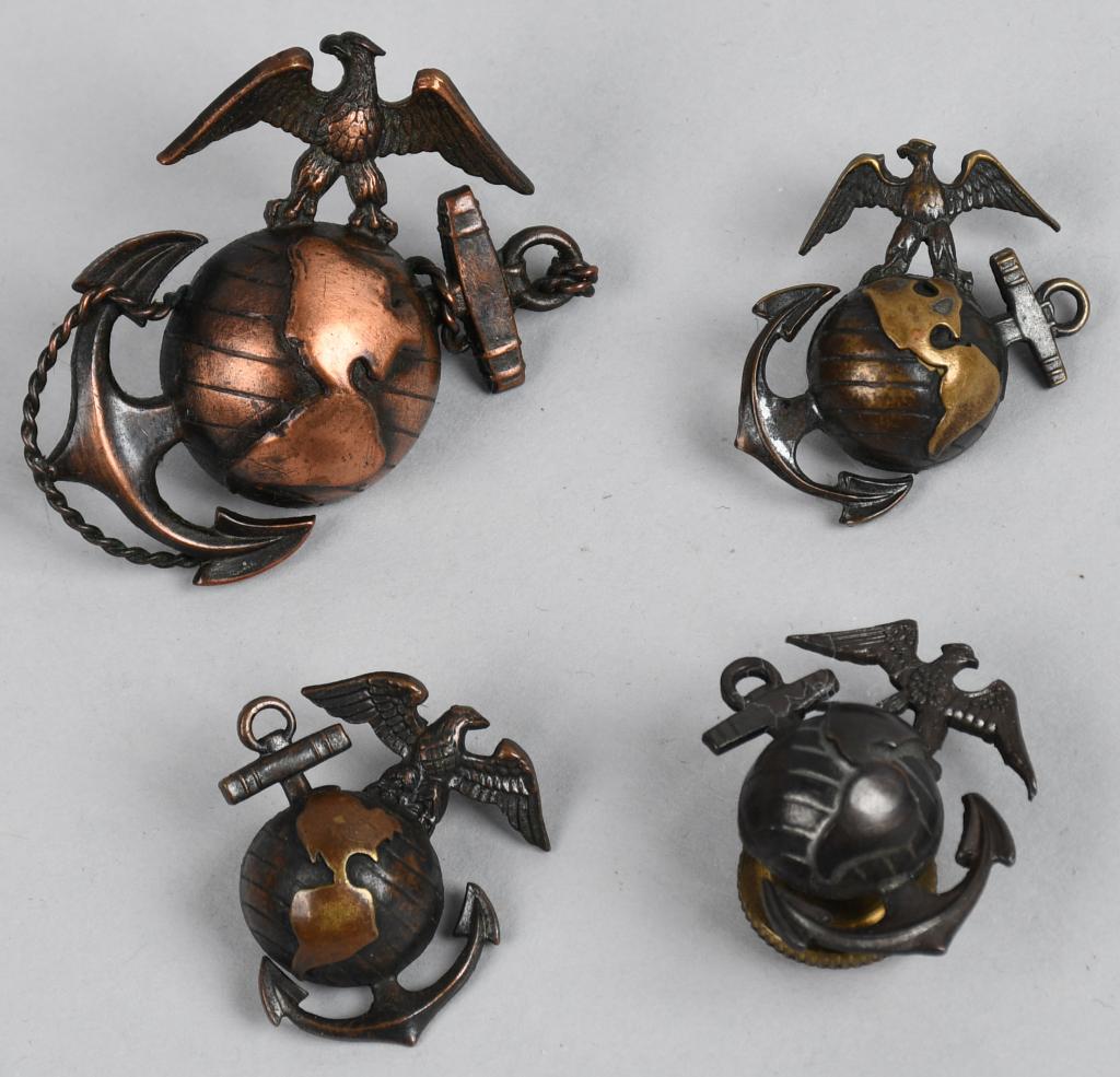 WWII US LOT OF 4 USMC OFFICER UNIFORM EMBLEMS: WWII era US Marine Corps emblems for USMC officer's. All of them are for the USMC Service winter green or summer khaki uniforms. Includes an H&H Imperial cap badge, two "left side" emblems, one Imperi