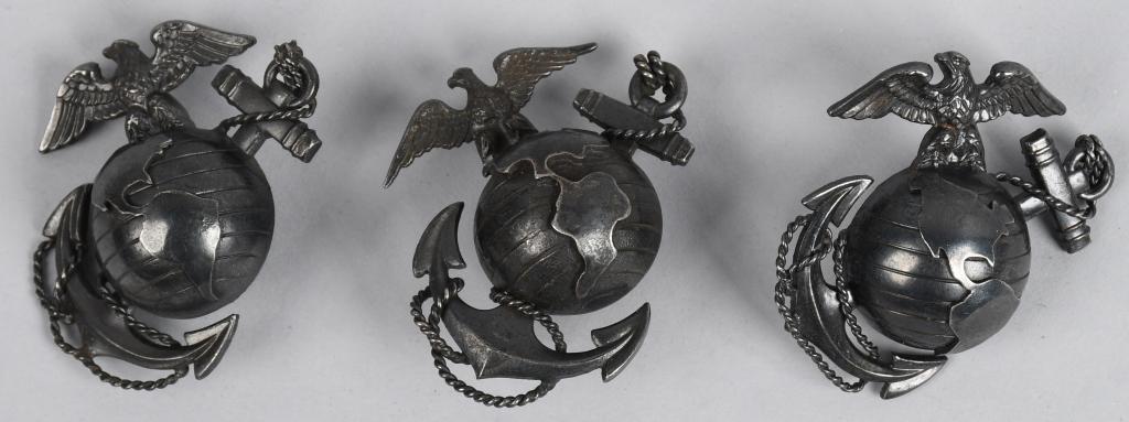 WWII US LOT OF 3 USMC OFFICER CAP BADGE EMBLEMS: Lot of 3 World War II and post-war era US Marine Corps officer cap badge emblems. All three are darkened in color and meant for wear on summer khaki or winter green service uniform caps. Large dome gl