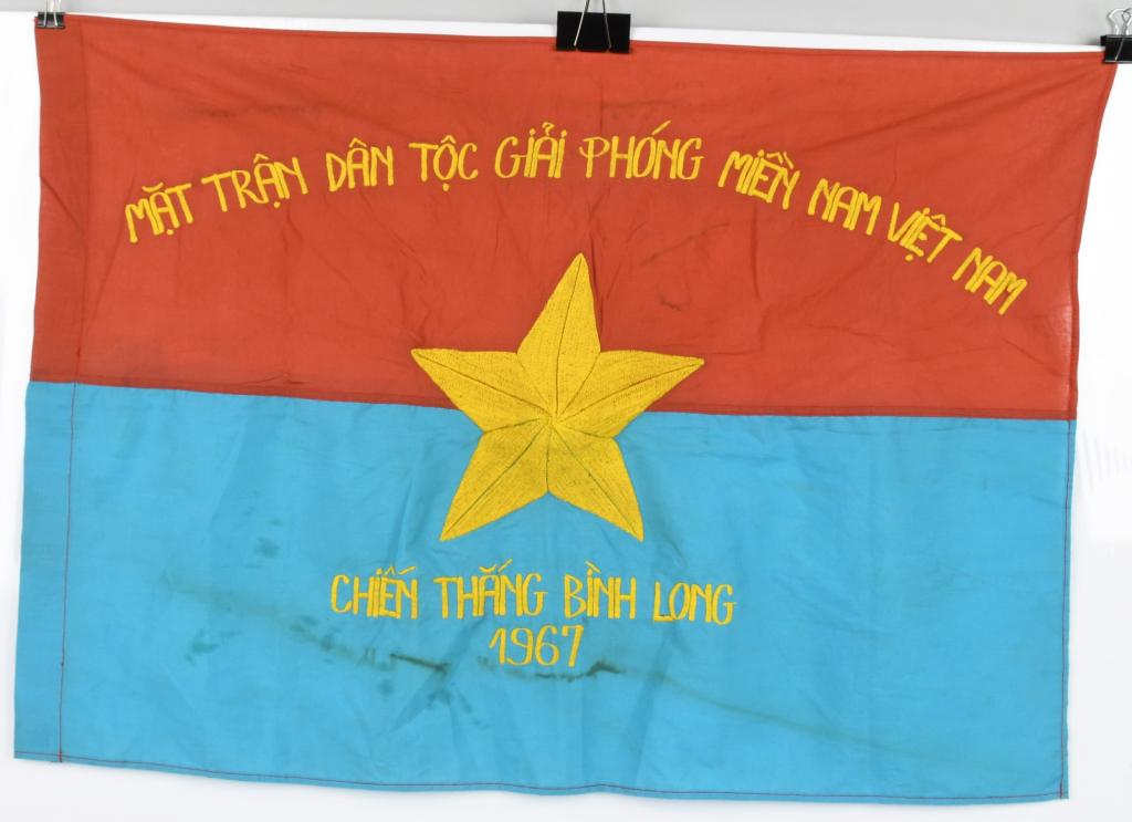 VIET CONG NLF BATTLE FLAG BATTLE OF BINH LONG 1967: Reads across the top in Vietnamese: "National Front for Liberation of South Vietnam" and at the bottom, "Battle of Binh Long1967" Single-sided machine embroidered flag - Measures approximately 28.5" x