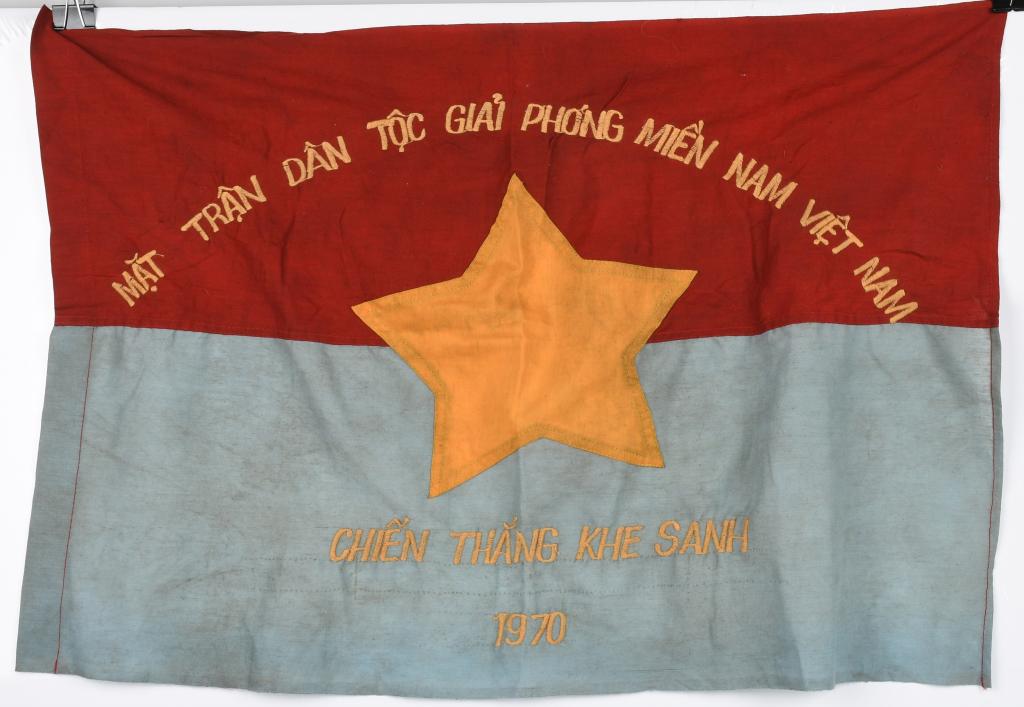 VIET CONG NLF BATTLE FLAG BATTLE OF KHE SANH 1970: Reads across the top in Vietnamese: "National Front for Liberation of South Vietnam" and at the bottom, "Battle of An Khe 1967" Single-sided machine embroidered flag - Measures approximately 28.5" x 1