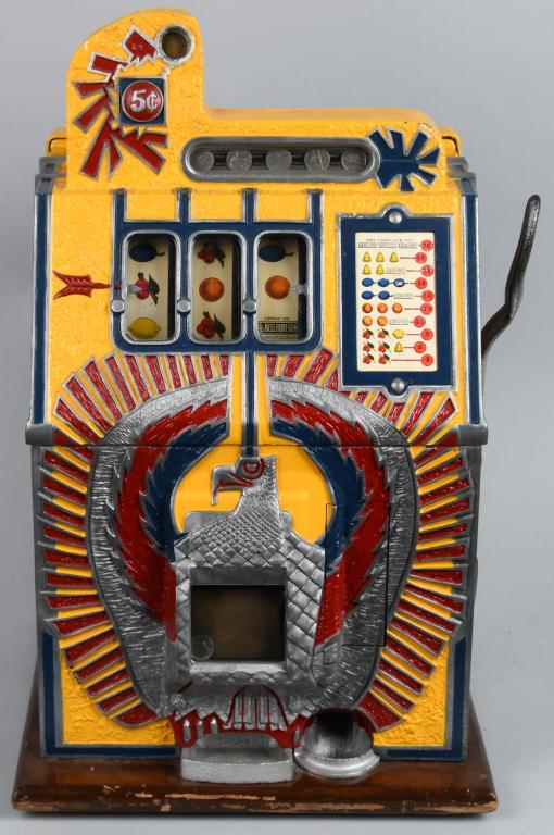 MILLS WAR EAGLE 5 CENT SLOT MACHINE: Machine is repainted. Top casting and back bonnet are have cracking. Back door and lock are original, missing cash box. Strips and award card are correct replacements. Plays and pays correctly. Good