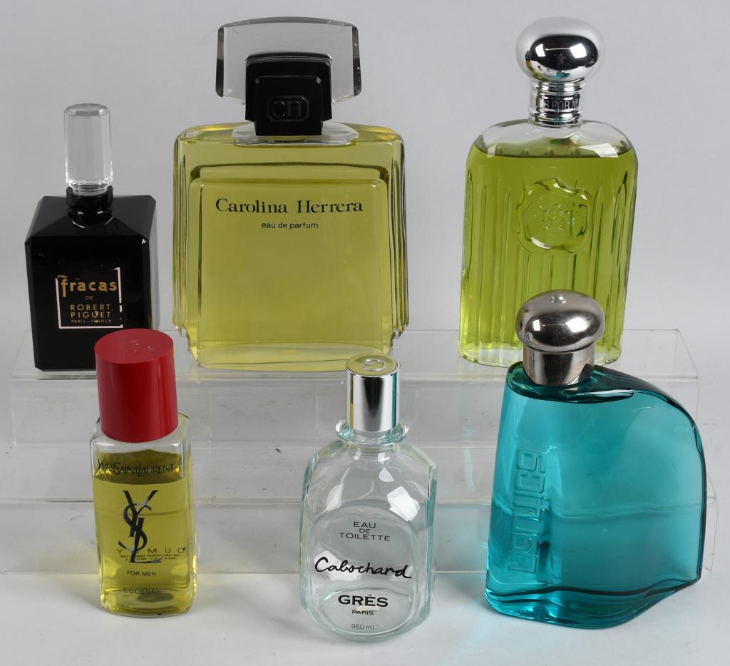 6- STORE DISPLAY PERFUME BOTTLES: Includes Cabochard, Yves Saint Laurent, Fracas with chip at neck., Carolina Herrera, Nautica, and Giorgio. Largest 12" Excellent