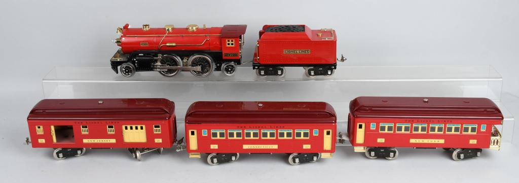 CLASSIC LIONEL FIREBALL STD. RED COMET TRAIN SET: A beautiful set that is not a reproduction as a standard gauge Red Comet set was never made before the war. Includes a 390E engine with tender and three passenger cars. Set does not appear to have eve