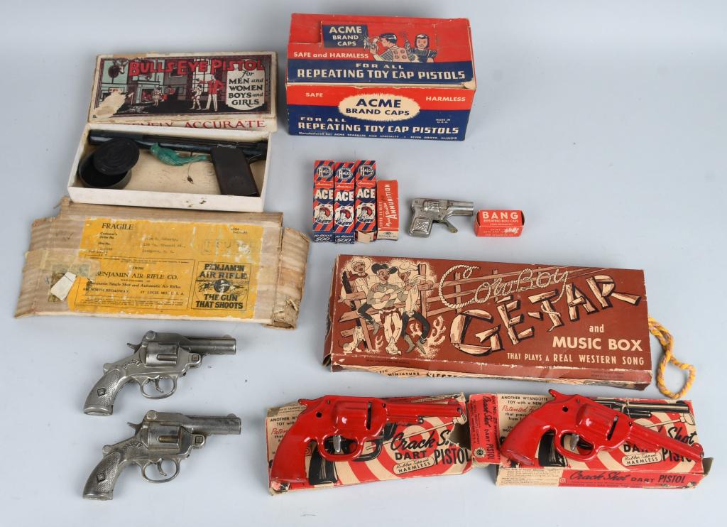 LOT OF TOY GUNS, CAPS, & MORE: Includes Box of Acme Caps, Crack Shot Pistol in Box, Bulls Eye Pistol in Box, 2- Safety Cast Iron Cap Guns, Cowboy Guitar with Box, and More.