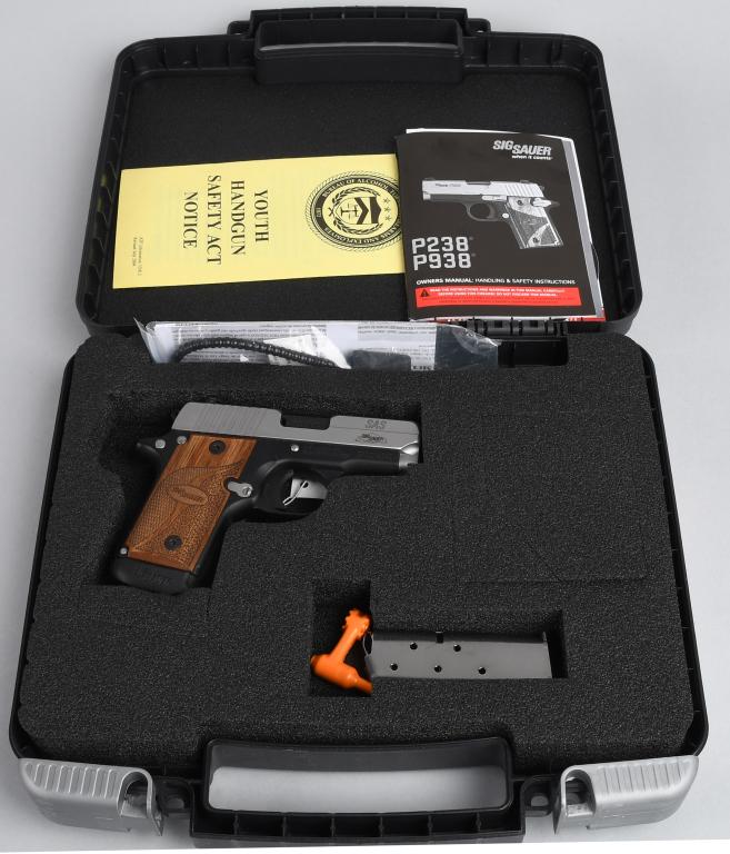 BOXED SIG SAUER MODEL P238 SEMI-AUTO PISTOL: Serial #27C014342. Barrel length 2 3/4". Caliber .380. Near or as new in original matching plastic box with paperwork and two magazines. Gun features a stainless slide with alloy frame and wood grips 