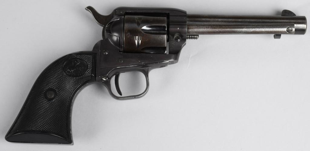 COLT SINGLE ACTION FRONTIER SCOUT REVOLVER: Serial #90635F. Barrel length 4.5". Caliber .22 rimfire. Made in 1959. Full blue finish with black plastic grips. The blue is thinning overall with wear on all the high spots. Action is fine as is the