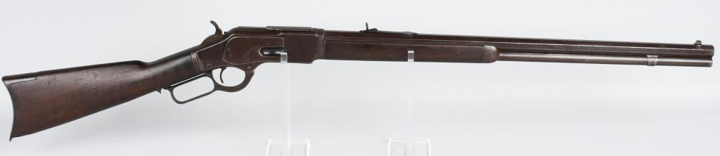 WINCHESTER MODEL 1873 LEVER ACTION RIFLE: Serial # 331489. Barrel length 24". Caliber .38-40. Made in 1890. This standard rifle features a full octagon barrel, full magazine, bead front sight, semi-buckhorn rear sight, blue finish, walnut sto