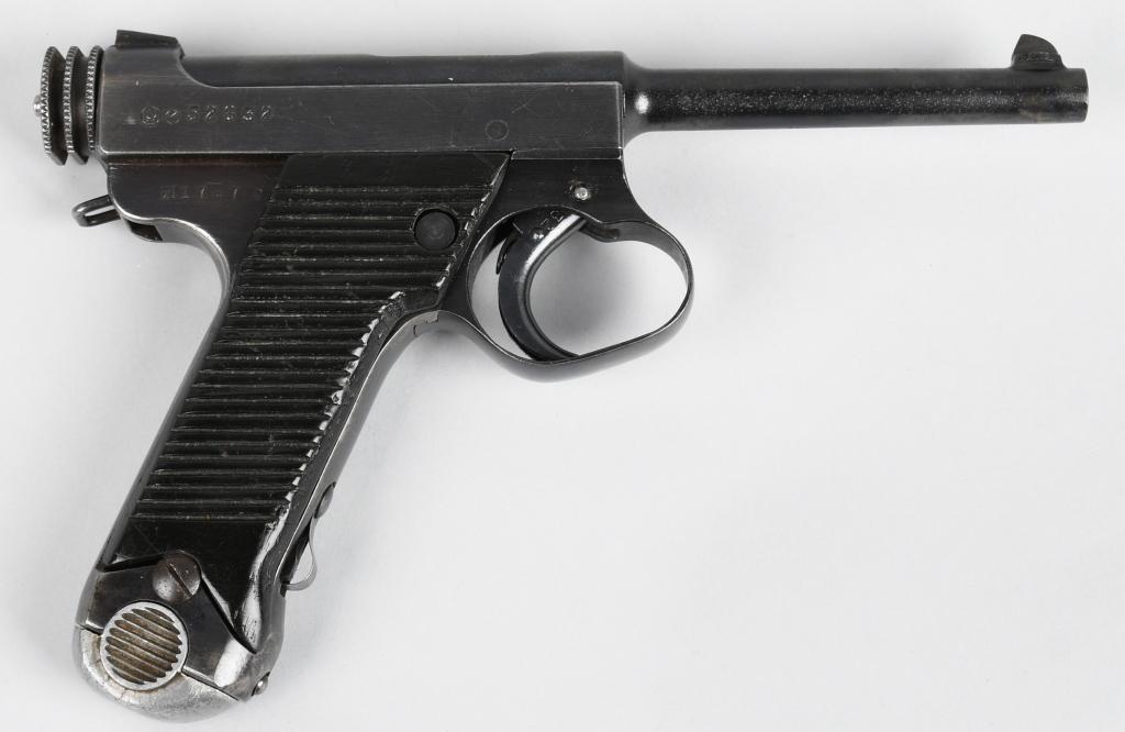 JAPANESE TYPE-14 NAMBU SEMI-AUTOMATIC PISTOL: Serial #52632. Barrel length 6". Caliber 8mm. This example is stamped Nagoya Arsenal Toriimatsh Factory Showa 17.7 made in 1942. Salt blue finish with some scattered pitting on barrel. Grips are numbe