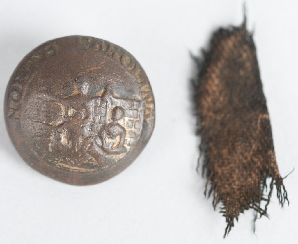 CONFEDERATE NORTH CAROLINA LOCAL COAT BUTTON: Original Confederate North Carolina coat size local button. Has depressed channel with no back mark. Nice excavated condition and includes a piece of cloth.Comple with shank. Very Good