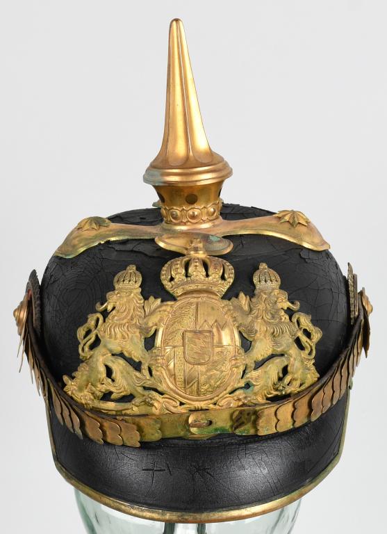 WW1 GERMAN BAVARIAN OFFICER'S PICKELHAUBE: Nice quality blackened lacquered leather construction pickelhaube with gilt brass metal fittings. The pickelhaube features a rounded body and crown with stitched on, extended, squared corner, front an
