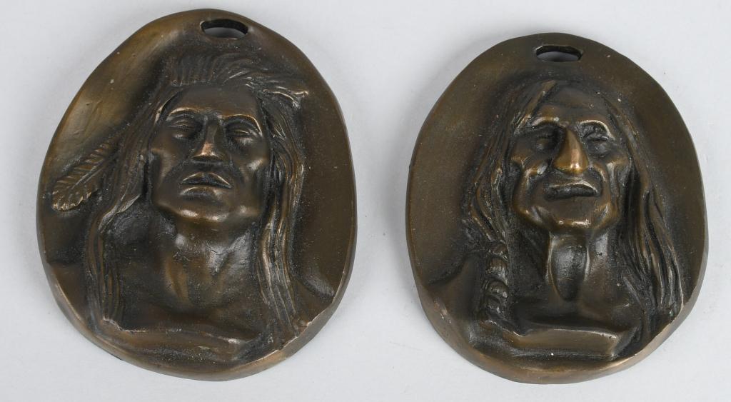 PAIR OF INDIAN HEAD BRONZE PLAQUES BY CM RUSSELL: Pair of Charles Marion Russell Indian Head Bronze Plaques Charles Marion Russell (American 1864-1926) sculptured these pair of Indian plaques for the Abercrombie & Fitch's New York City department sto