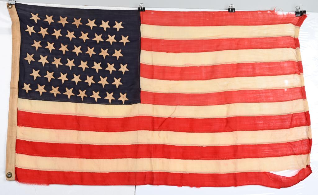 SPANISH AMERICAN WAR ERA US 45 STAR FLAG: Historic flag made of wool with separately applied cotton stars on a blue field. he 45-Star Flag: This Flag became the Official United States Flag on July 4th, 1896. A star was added for the admission