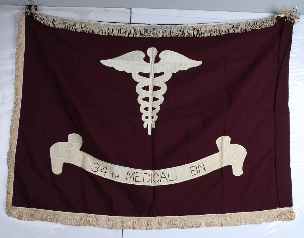 WWII US 34th MEDICAL BATTALION GUIDEON FLAG: 3' x 4' maroon silk flag with caduceus and banner with white tassel trim. Guide on flag of the 34th Medical Battalion. Has cloth label in the spine from Philadelphia Quartermaster Depot and leather ta