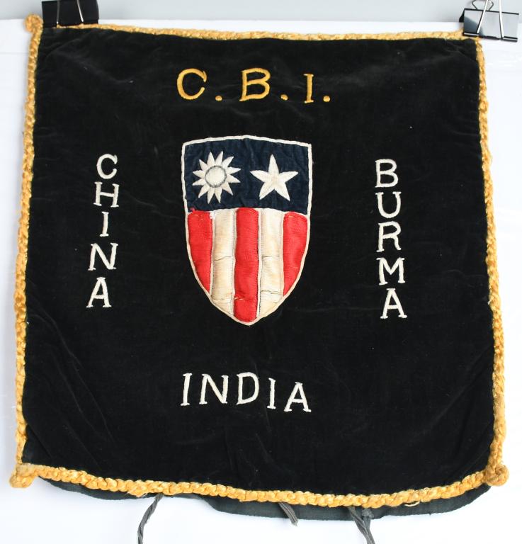 WWII CHINA BURMA INDIA EMBROIDERED PILLOW COVER: Measures approximately 14" x 14" with gold colored trim. Marked "C.B.I." and "China Burma India" and features a fully embroidered version of the famous CBI command insignia in the center. Yellow pipin