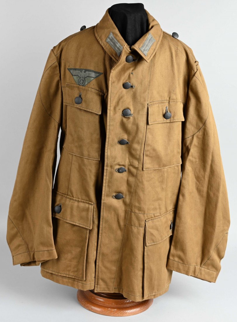 WWII NAZI GERMANY TROPICAL HEER TUNIC MINT: Light weight ribbed, khaki/olive cotton twill construction field blouse features a vertical six button front closure with small opened fold back peak lapels and a lay down collar. The field blouse has