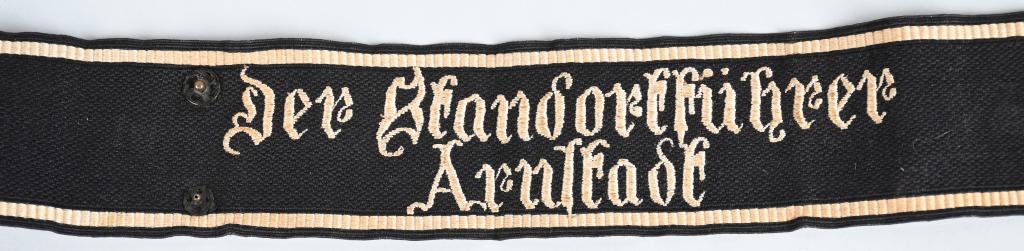 WWII Nazi German SS Der Standortführer Cufftitle: Roughly, 2 1/4", (5.8cm), tall, 19 3/8", (49.2cm), long, full length, machine woven, black rayon construction cufftitle features machine embroidered, Fraktur/Gothic styled script, "Der Standortführer