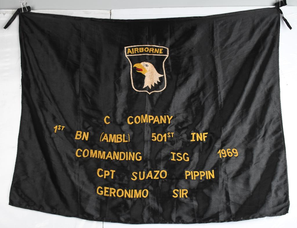 VIETNAM US THEATER MADE 101st AIRBORNE FLAG: Embroidered black silk flag measures approximately 36" at the spine and 46" across. Center has iconic "screaming eagle" of the 101st Airborne Division and reads across the bottom C Company, 1st Battal