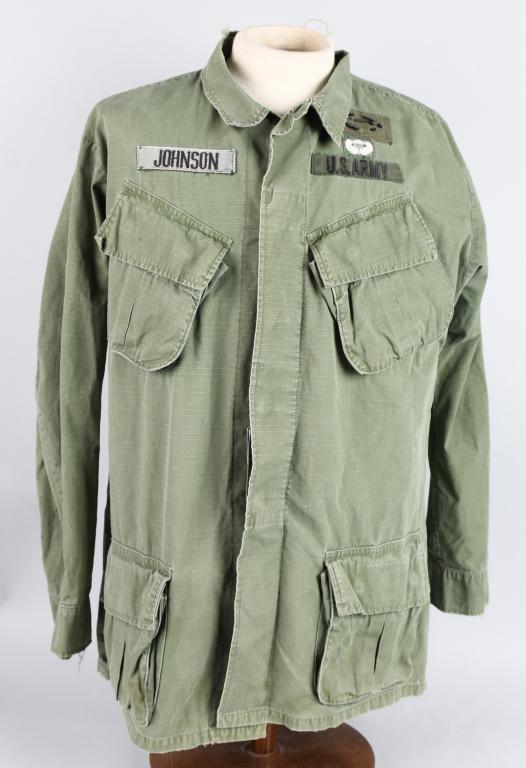VIETNAM US 101st AIRBORNE JUNGLE JKT WITH DOG TAGS: Vietnam War era 1969 dated 3rd pattern jungle jacket with full color 101st Airborne shoulder patch on left sleeve, OD Green and white basic parachutist jump wings and badly worn theater-made Combat In