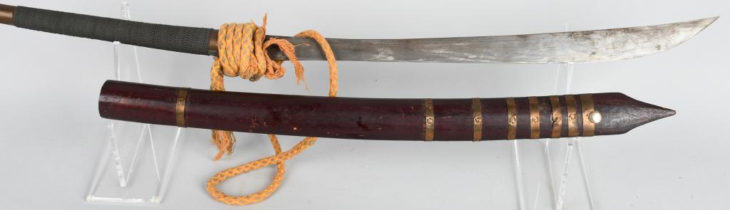 VIETNAM MONTAGNARD DHA SWORD & SCABBARD WITH CORD: Vietnamese indigenous Montagnard dha style sword with approximately 20" blade, approximately 30" overall. Wire wrapped handle, brass pommel, rattan scabbard, and yellow / red / green cord. Shows age a