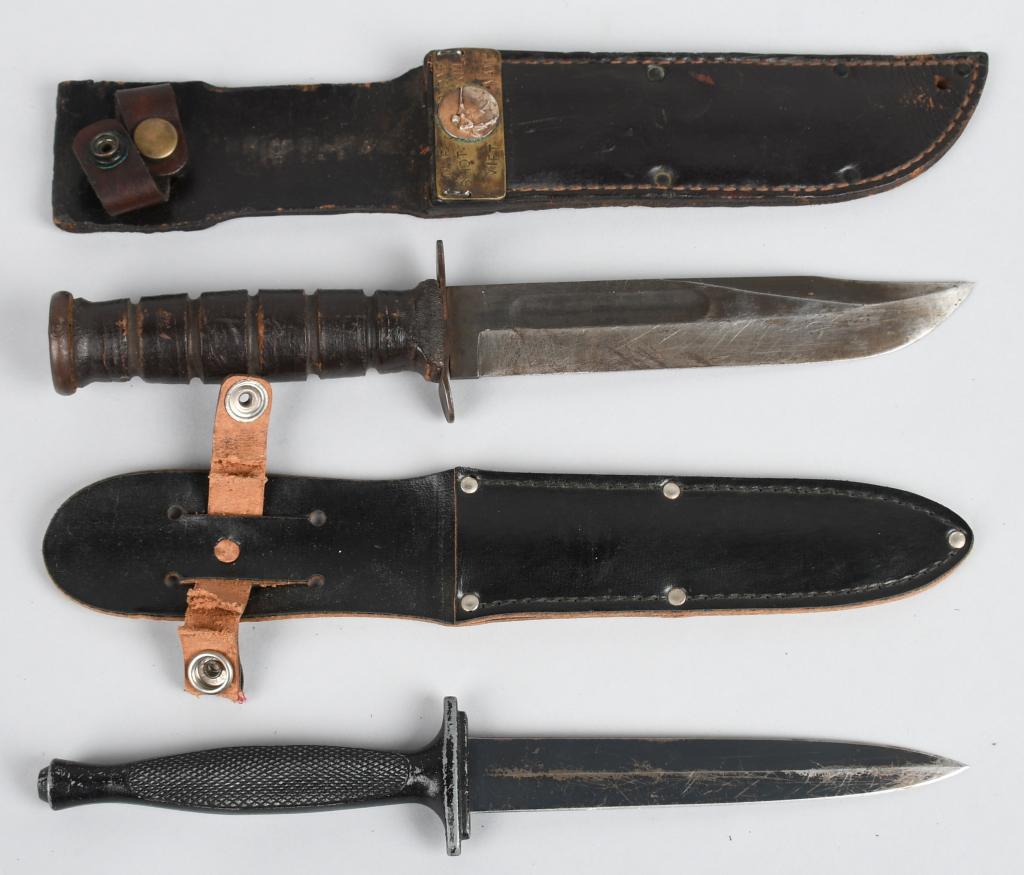2 VIETNAM WAR US FIGHTING KNIVES KA BAR USMC SNIPR: Pair of Vietnam or post-Vietnam war era fighting knives. One is a black handled, unmarked version of the Fairbairn Sykes commando knife with a 6" dagger style blade and 11.2" overall in a leather shea