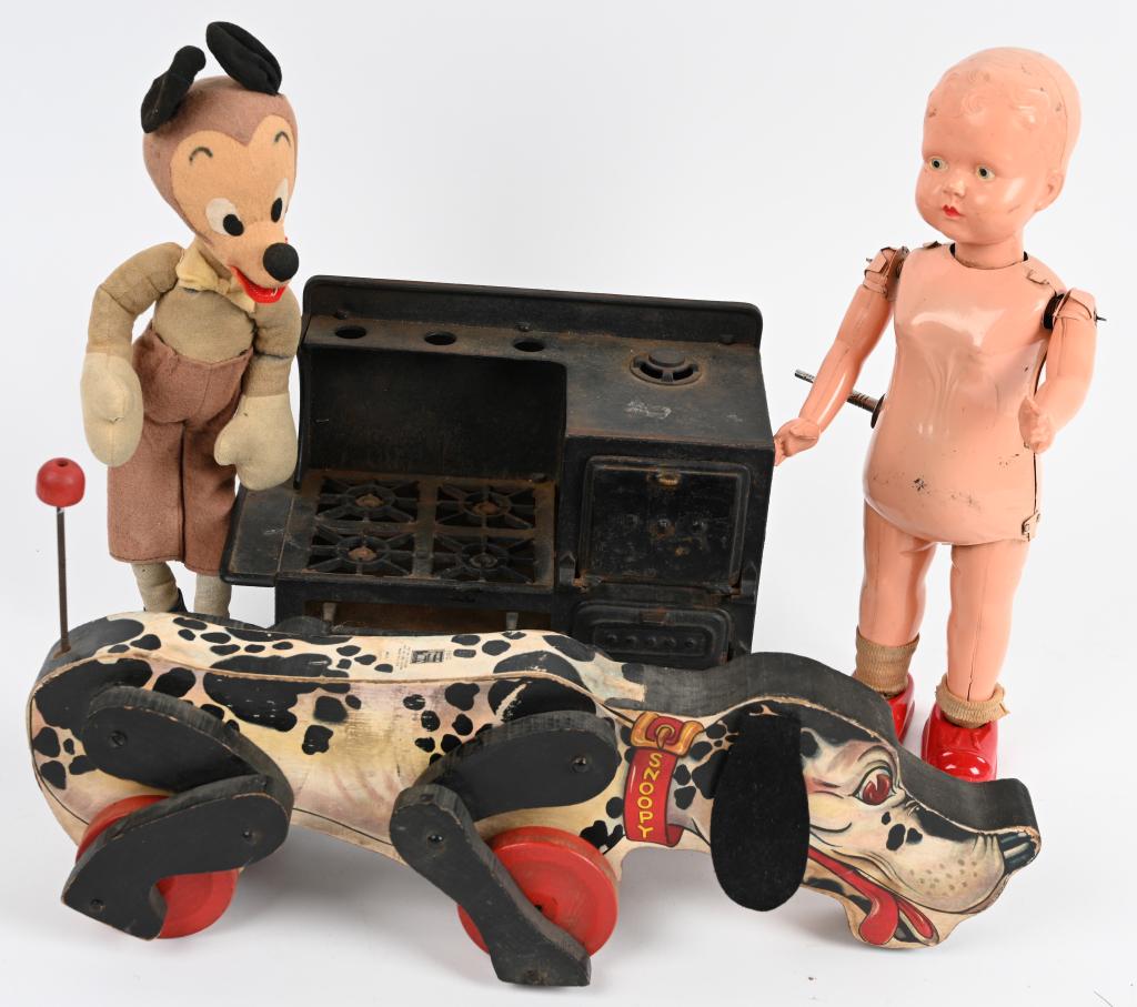VINTAGE TOY LOT: Lot includes tin windup 13 1/2" doll with plastic head that worked whne tested, a cloth 13" Wolf Doll, a 17" Fisher Price No. 180 Snoopy Dog, and early cast iron toy stove measuring 7 1/2" by 10". the