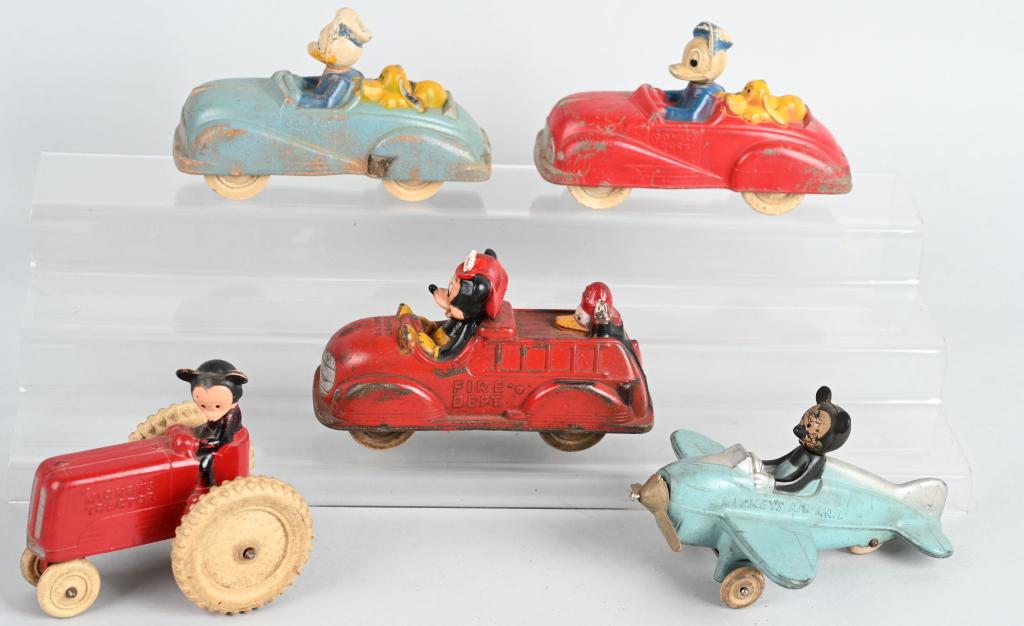 5- WALT DISNEY SUN RUBBER VEHICLES: Nice lot includes 5 different Walt Dinsey productions Sun Rubber toys. Lot includes a red and blue Donald Duck Roadster, a Mickey Mouse Air Mail plane missing part of prop, a Mickey Mouse Fire truck w