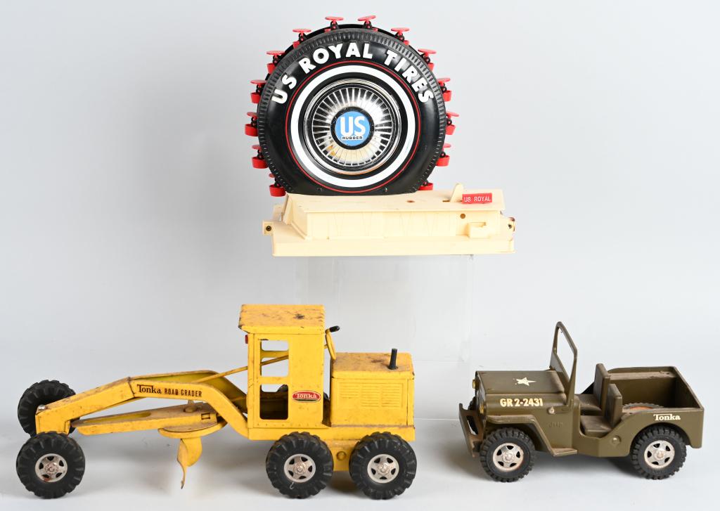VINTAGE TONKA TOYS & US ROYAL TIRE TOY: Lot includes a Tonka Road Scraper, a Tonka Jeep and a U.S. Royal Tire Advertising battery operated toy. The Tonkas should clean to a higher grade and the Jeep is missing the steering wheel. The US Roy